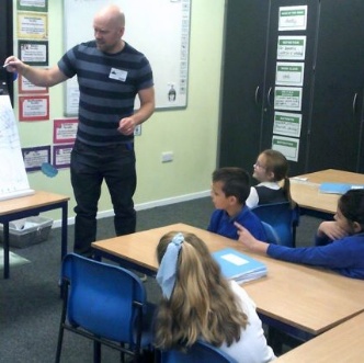 Photo of author talking to children