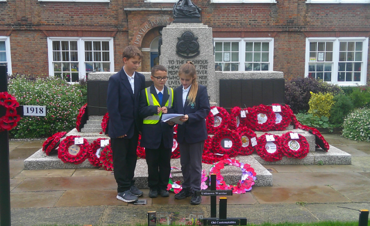 Photo of children laying wreaths
