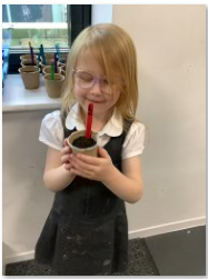 Photos of child holding plant pot