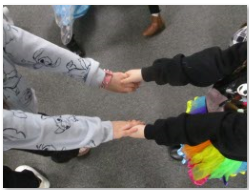 Photo of children making shapes with hands 