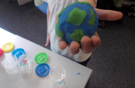 Photos of children making planets from playdough