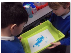 Photo of children making art with straws