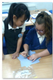 Photo of children mummifying a tomato