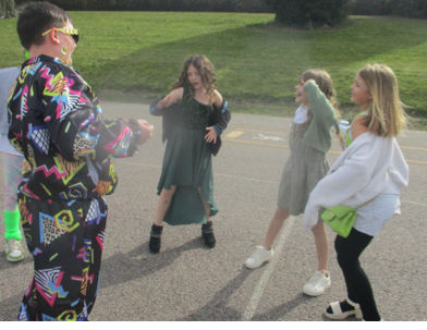 Photo of children dressed up and dancing for Red Nose Day
