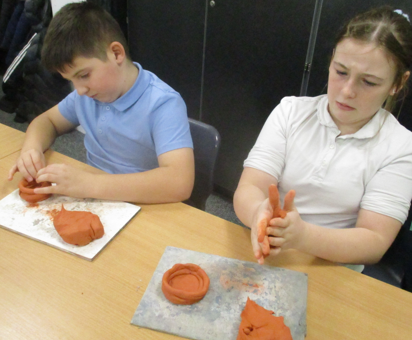 Photo of children making Mayan pots