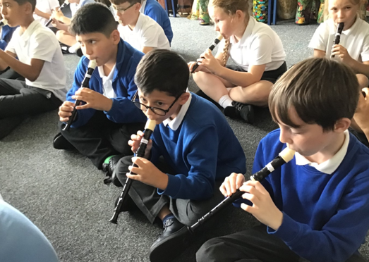 Photos of children playing recorders
