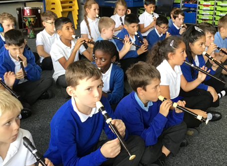 Photos of children playing recorders