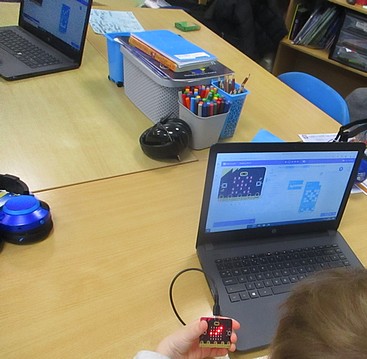 Photo of children programming Microbits
